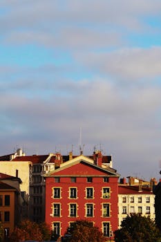 Vivid urban residential buildings under a blue sky with clouds.