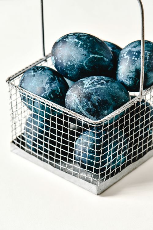 Free Artistic blue eggs in a wire basket on a white background, perfect for Easter themes. Stock Photo