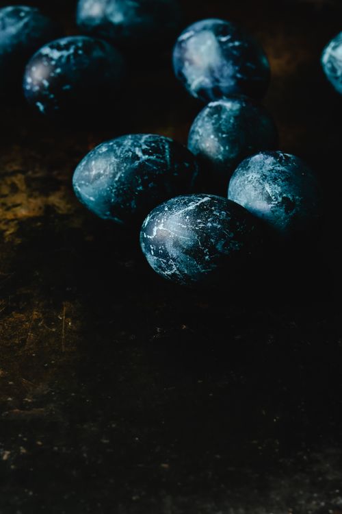Free Moody still life of dark blue Easter eggs on a textured surface. Stock Photo