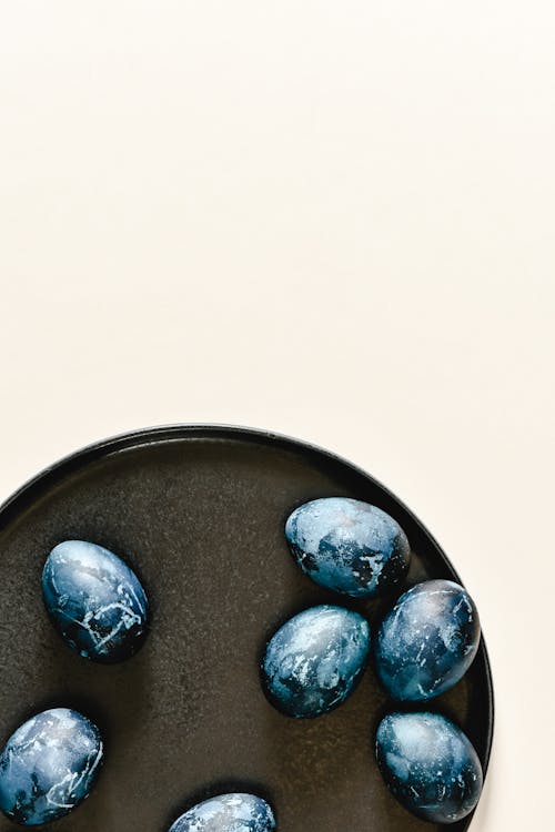 Blue and Black Eggs on Black Round Plate