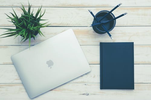 Top Viiew Photo of Macbook on Wooden Surface