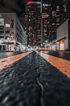 A low-angle night shot of skyscrapers and city street in Atlanta, GA.