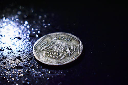 Close-Up Photo of Wet Coin