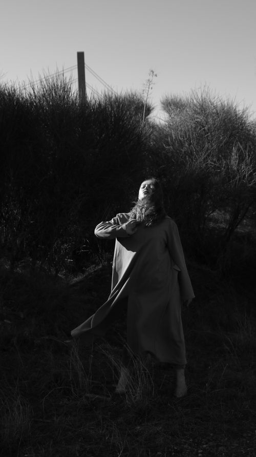 Free Black and white portrait of a woman outdoors, capturing a dramatic mood and ethereal pose. Stock Photo