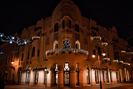 Night view of a beautifully lit Art Nouveau building decorated with Christmas lights in Szeged, Hungary.