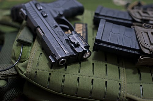 Free Pistol Beside Loaded Cartridges Stock Photo