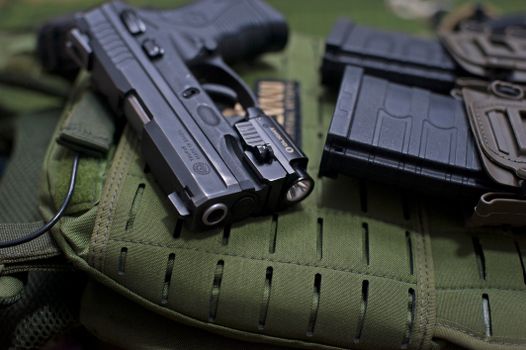 Pistol Beside Loaded Cartridges