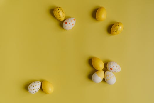 Decorative Easter eggs on a bright yellow surface, perfect for holiday themes.
