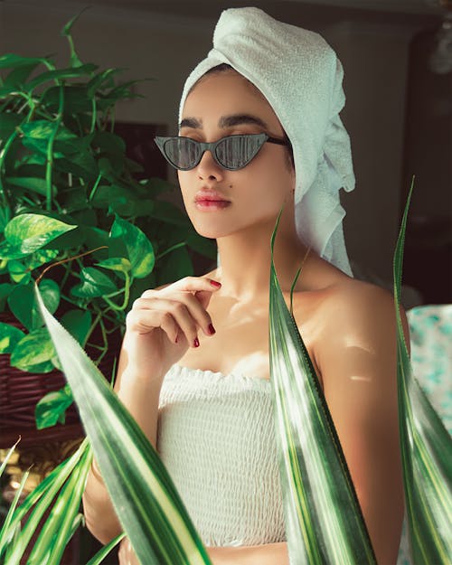 Free A Woman in White Tube Top Wearing Sunglasses Stock Photo