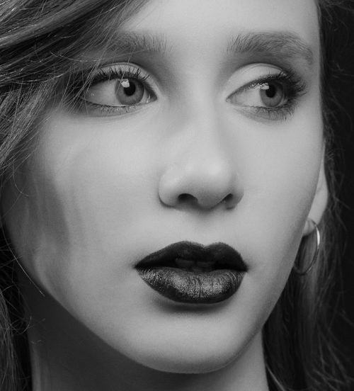 Free Black and white close-up portrait of a woman with intense gaze in Kyiv. Stock Photo