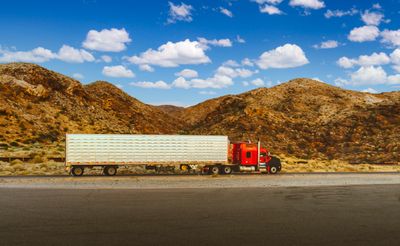 Red semi truck on desert highway