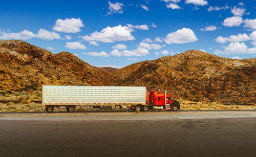 Red semi truck on desert highway