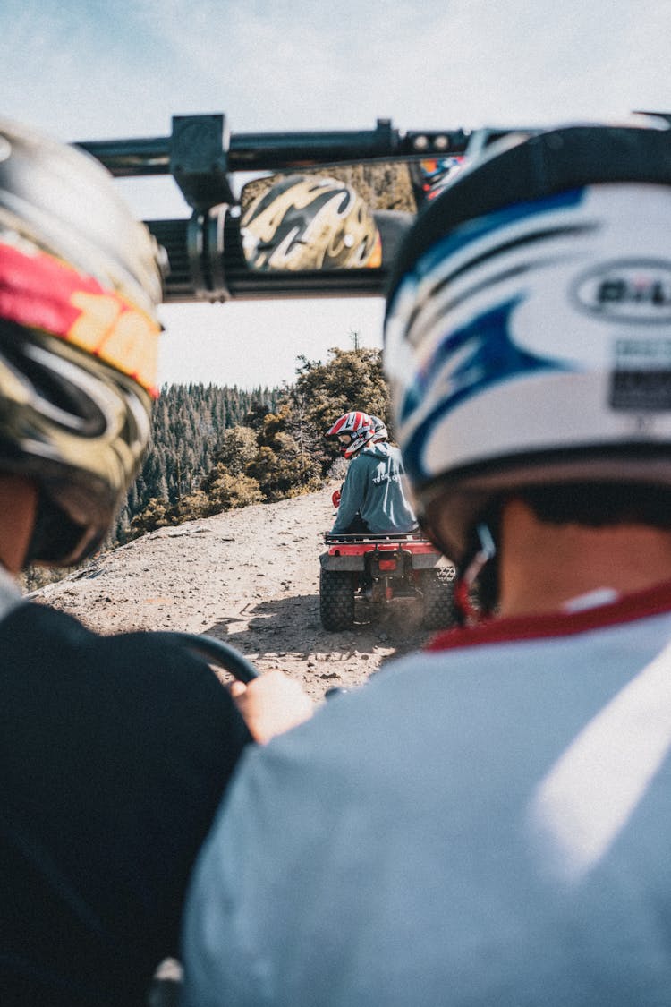 People Riding In Quad Bikes Wearing Helmets 