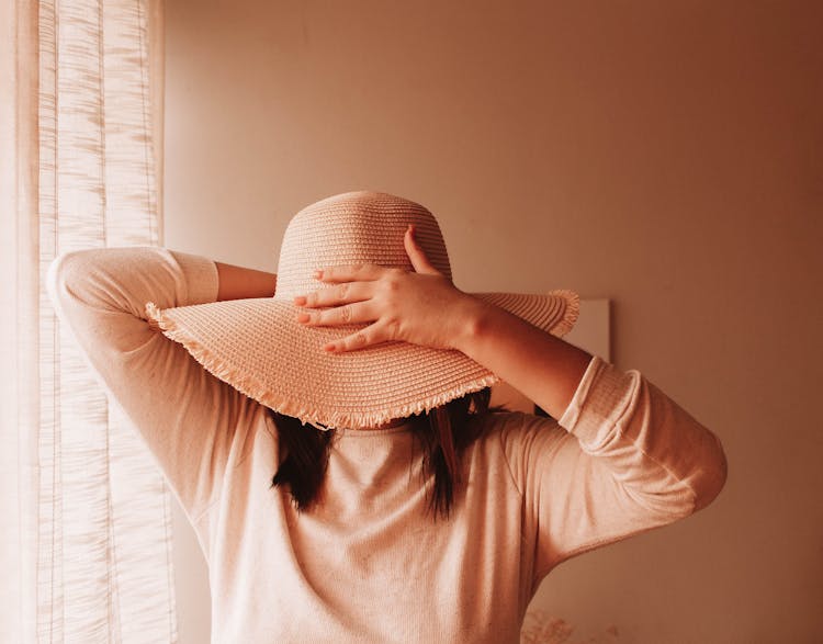 Unrecognizable Woman In Hat At Home In Sunshine