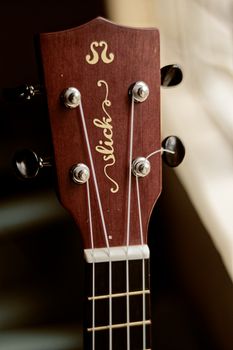 Acoustic ukulele headstock in light room