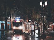 Tram driving in city at night