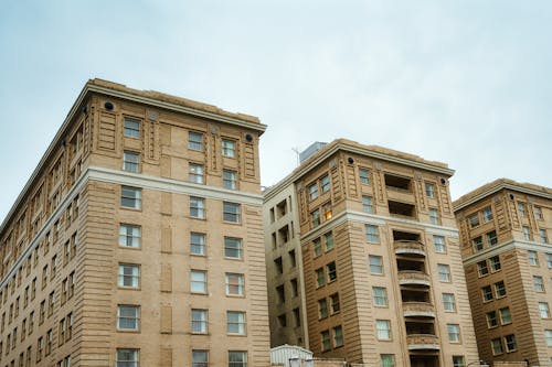 Exteriors of old buildings in residential district under cloudy sky