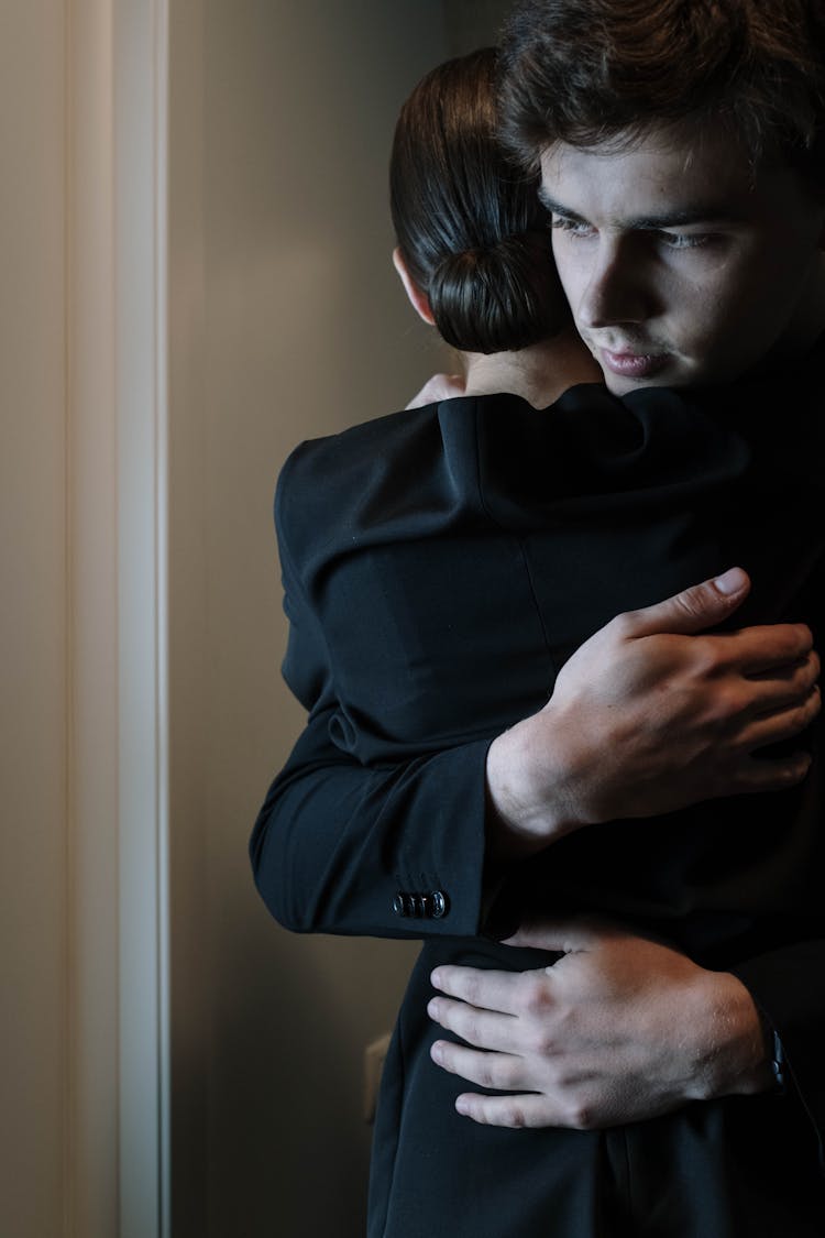 A Man Hugging A Woman