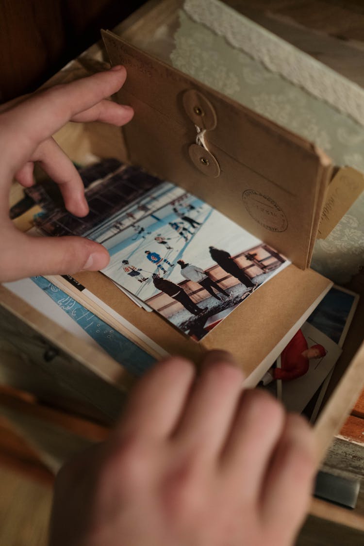 Person Looking Into A Box Of Memorabilia