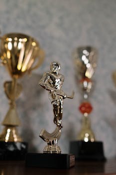 Shiny hockey trophy with blurred background highlighting achievement and success in sports.