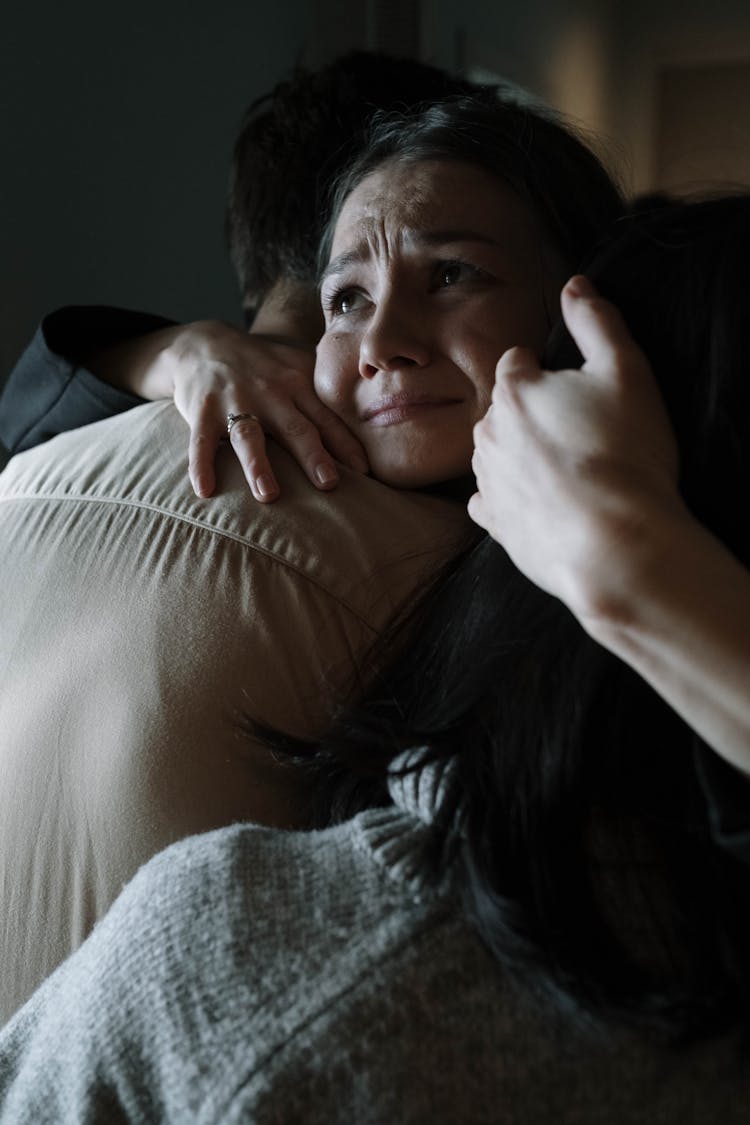 A Woman Crying While Hugging The Man 