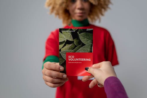 Person holding Red Brochure