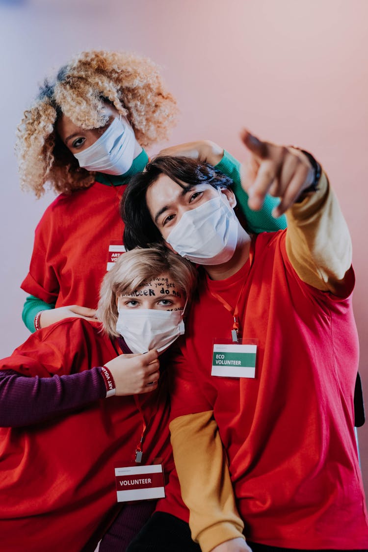 Three People In Red Crew Neck Shirts With Face Masks