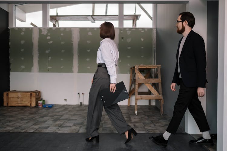 A Woman And Man Walking Together 