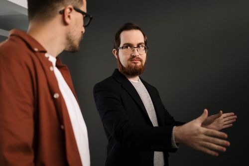 Free Two businessmen having an in-depth discussion indoors, focusing on collaboration. Stock Photo