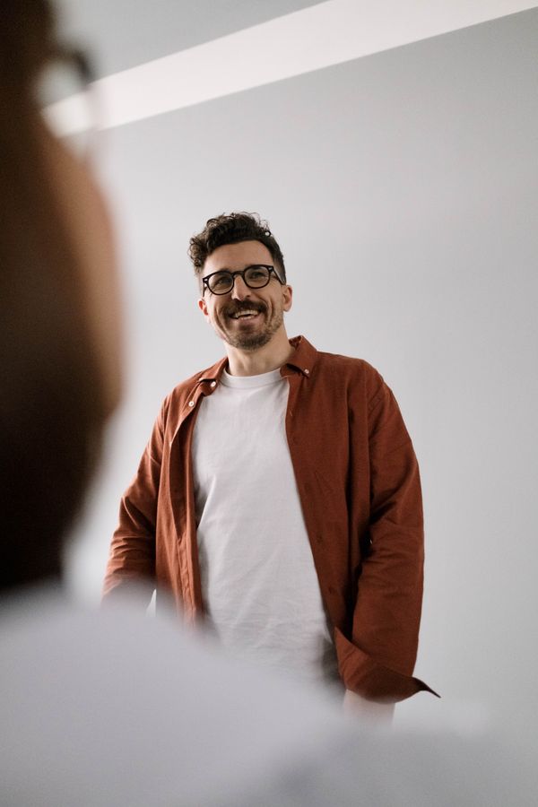A teammate laughing between conference sessions — photo by cottonbro studio on Pexels