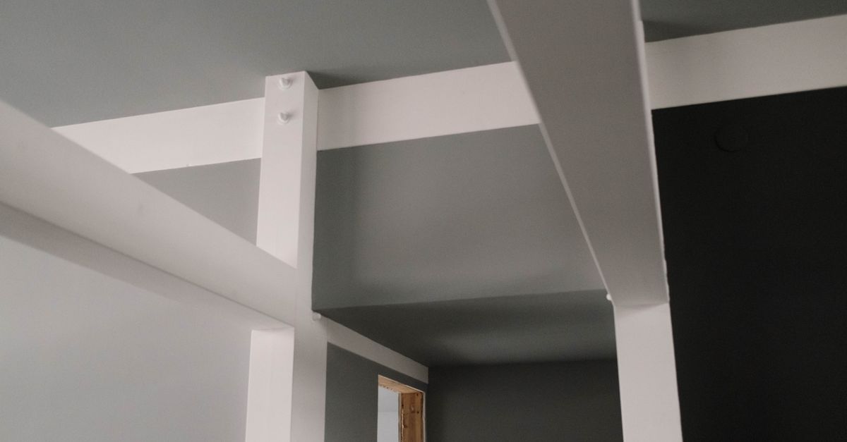 Close-up shot of subtle, minimalist sensors embedded in a wall and ceiling