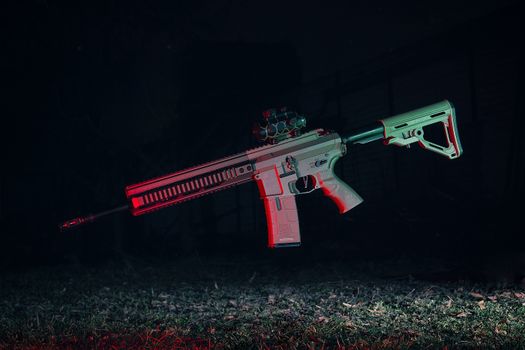Airsoft rifle in midair with dynamic lighting and dark backdrop.