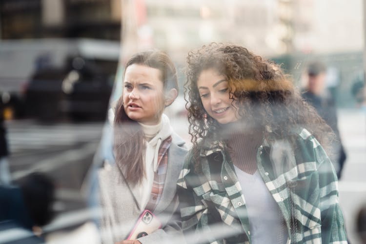 Through Window Of Diverse Women Near Showcase