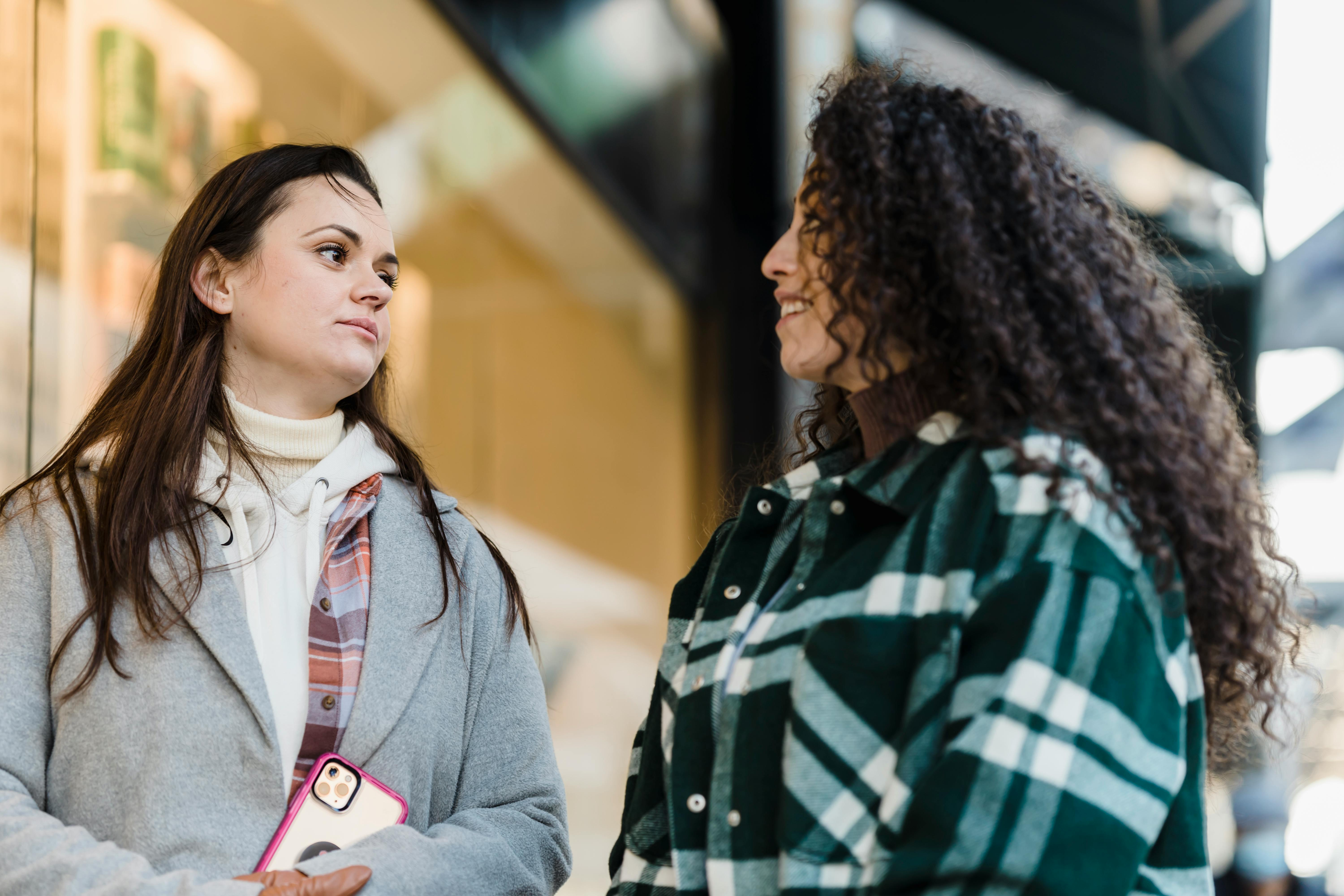 content multiethnic women on street near store