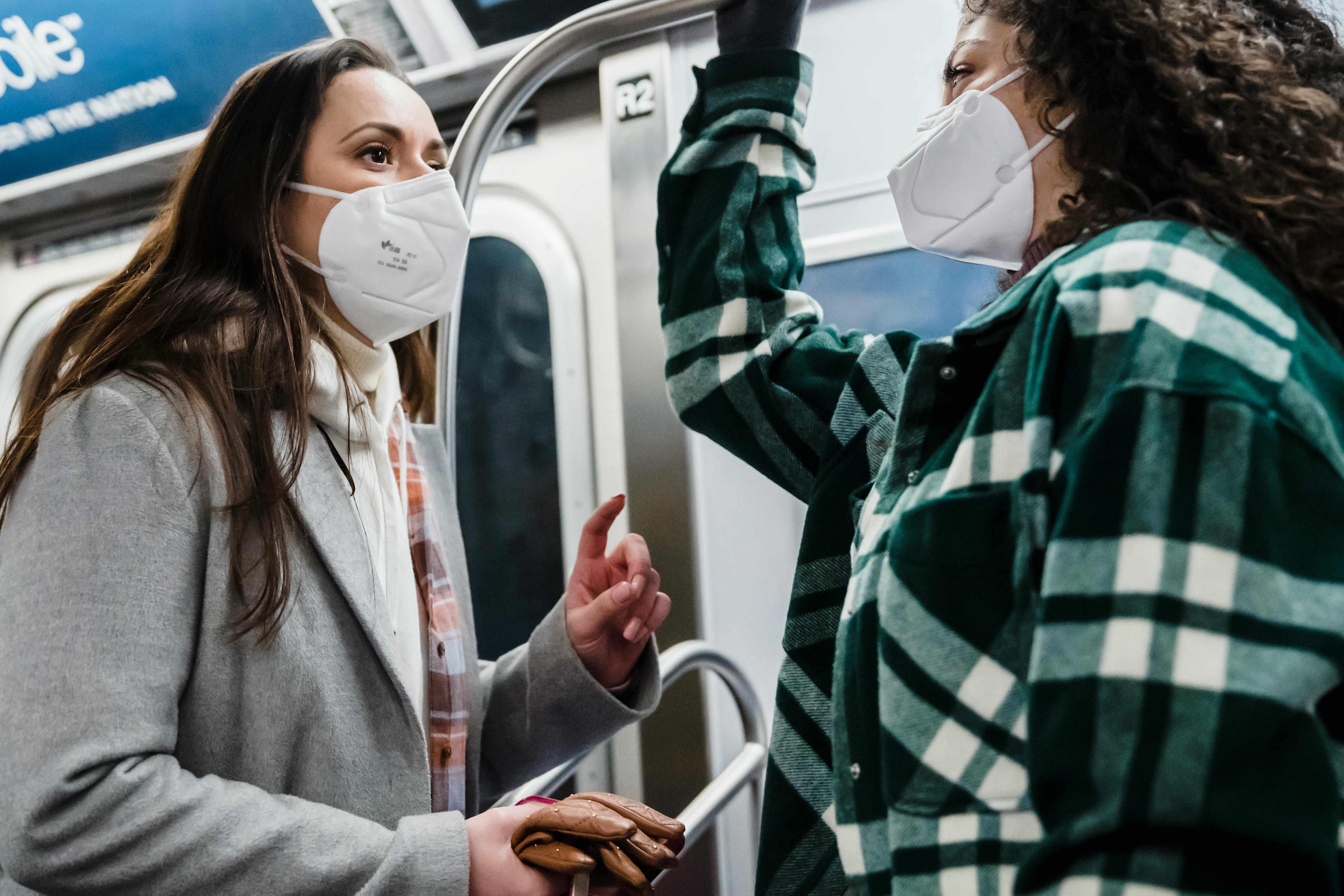 diverse women in medical masks in subway train