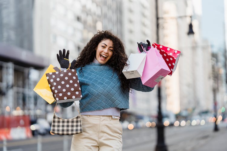 Positive Woman With Many Different Colorful Gift Bags