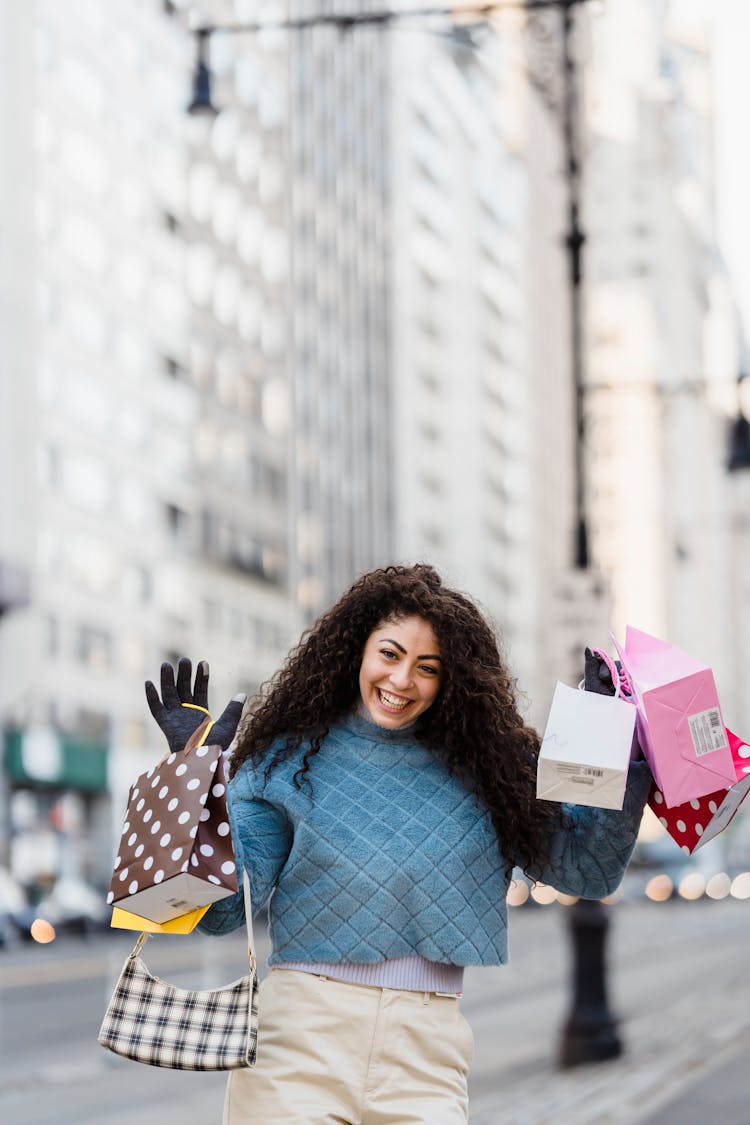 Young Woman Smiling With Bright Gift Bags