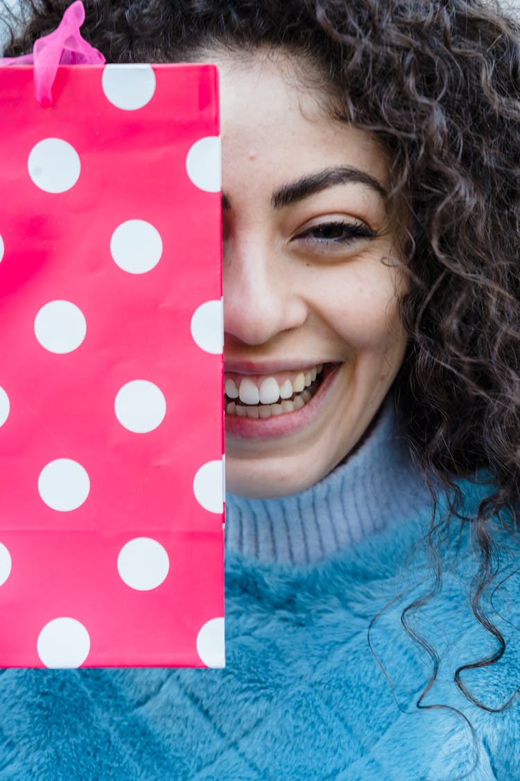 Woman With Colorful Pink Gift Bag And Curly Long Hair