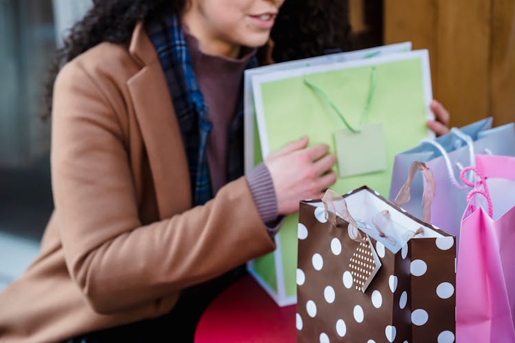 Woman Sitting In On Table With Gift Bags