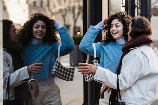 Two young women enjoying a casual conversation outdoors with city reflections.