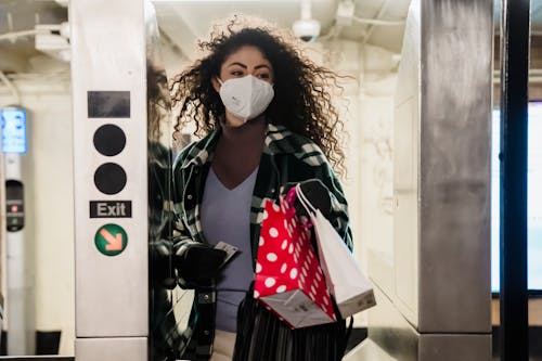 Free Woman walking through turnstile in subway Stock Photo