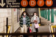 Female friends walking in underground passage after shopping