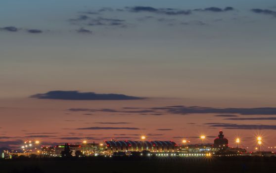 Illuminated cityscape at dusk showcasing urban lights and vibrant skyline.
