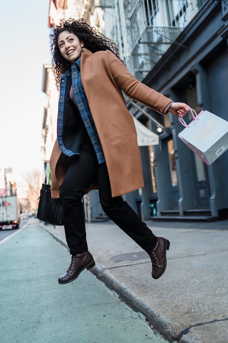 Joyful Ethnic Woman With Gift Bags