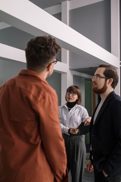 Free Professionals engaged in lively discussion in a contemporary office environment. Stock Photo