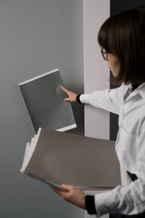 Free A businesswoman in an office organizing and handling documents efficiently. Stock Photo