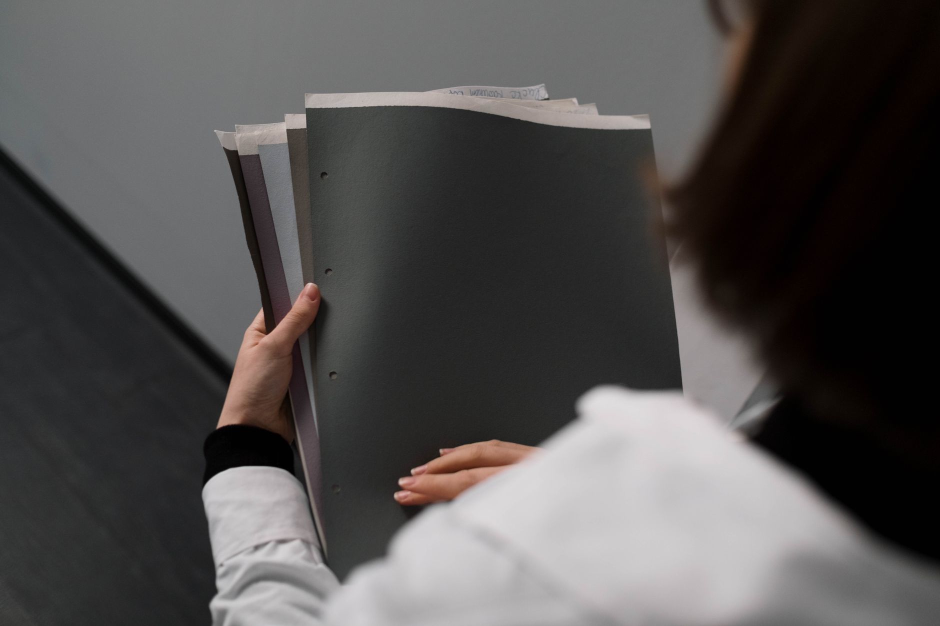 A person reviewing organized documents and receipts, the kind of evidence trail a coach needs when responding to a payment dispute
