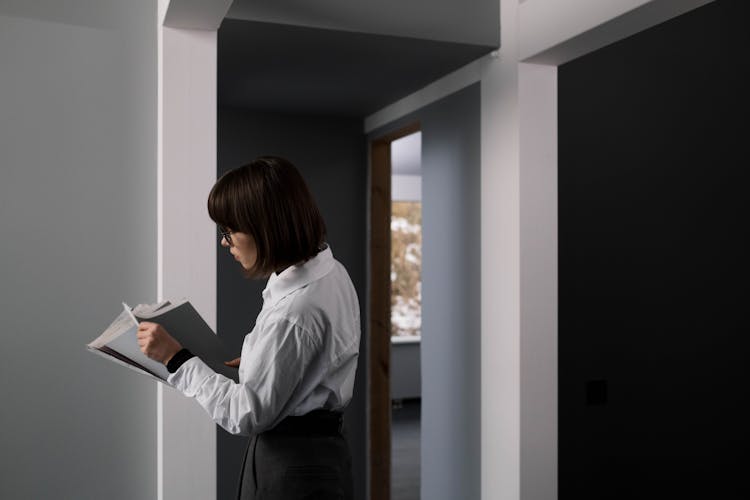 A Woman In White Long Sleeves Inside The House