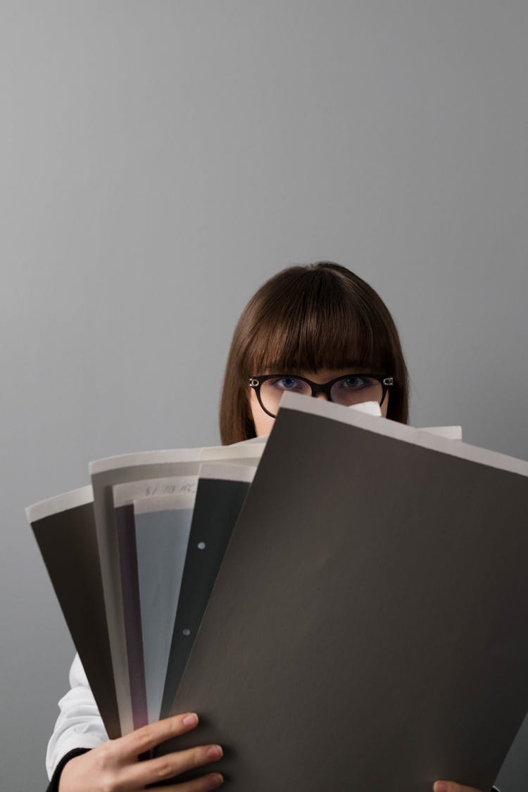 Woman Holding Paper Samples 