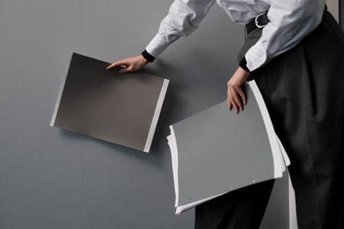 Free A person holding design samples while planning an interior project indoors. Stock Photo